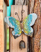 Cutwork metal butterfly decoration hanging on wood fence