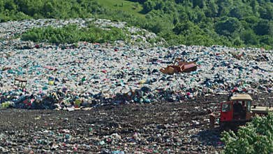 Man holding there is no planet B banner near pile of waste
