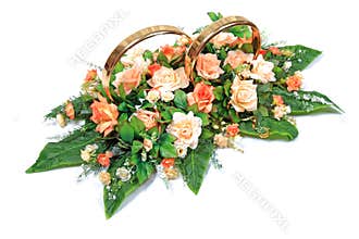 Wedding Rings Flowers Bouquet: Golden Marriage Bands With Peach And White Roses On Green Leaf Arrangement Against White Background