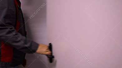 Close-up of a hand using a white keycard to open an electronic door lock with an access control system.