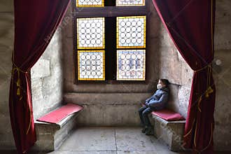 Boy sitting on a bench in the castle