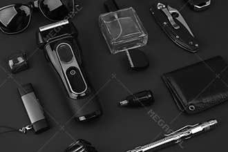 Men`s casual accessories on stone background. Watch, screwdriver, knife, glasses, USB stick, car keys, purse, electronic cigarett