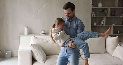 Young father play at home with little 9s daughter