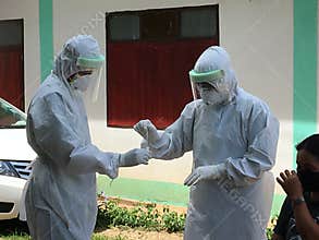 Medical team conduct COVID-19 coronavirus Rapid test PCR test ,cover in PPE suit, CDCU team Buriram province, Thailand