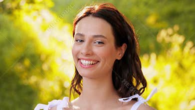portrait of happy smiling woman at summer park