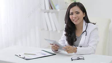 female doctor using tablet pc