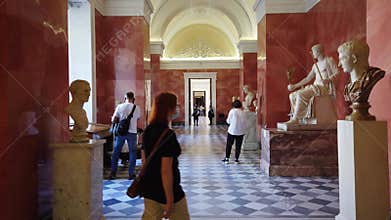 A splendid exhibition hall of the Hermitage with exhibits and groups of tourists