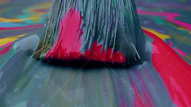 Navy paint with multi-colored blotches spread with brush