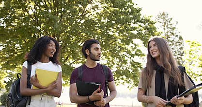 Multi racial students discussing topic at campus