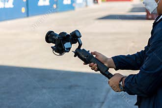 Steadicam with DSLR camera for video production are shooting movie in wedding ceremony. stabilize tool. stabilizer control machine
