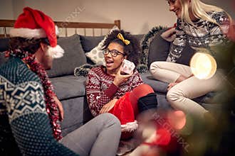Girl with gift celebrating christmas with  friends