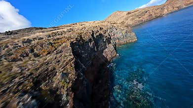 FPV racing drone Mountain surfing, and cliff diving along the rocks. Epic mountain landscape and ocean on Madeira island
