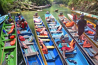 Boat keeper or boatman resting and talking while waiting for visitors to return at Gunung Mulu National Park, Sarawak, Malaysia
