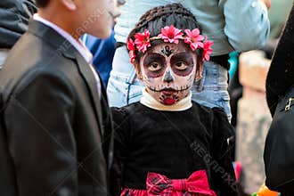 Little girl dressed in zombie costume at Halloween celebration