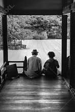 An elderly couple relaxing in a Zen garden