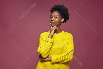 Pensive african american young girl touch chin lost on thoughts thinking planning future, dreaming, looking at camera