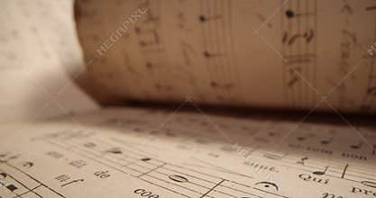 Musical sheet, music background. Vintage Sheet Music. Camera moving over a music sheet showing notes. Close up of music notes on a