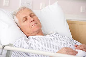 Elderly man sleeping in hospital bed