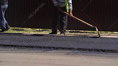 Road repair industry asphalt construction traffic transport. Paving machine distributes hot asphalt onto the road while