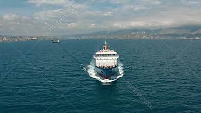 Drone shot of an oil tanker leaving port to carry cargo across the sea