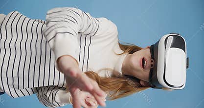 Youth Asia girl looking in goggles headset, amaze something like reality in front looking around virtual screen stand isolated on