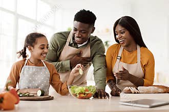 African American Family Cooking Making Salad Preparing Meal In Kitchen
