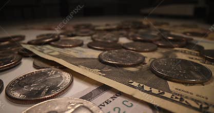 Lots of American dollars banknotes and falling coins on dark background