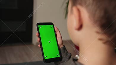 Young lad using video chat on smartphone at home, closeup. Space for design.