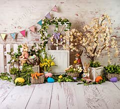 Easter spring sett up with colourful flowers pink and yellow flowers,bunny and easter eggs and vintage wood parquet
