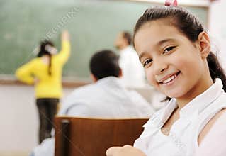 Adorable girl smiling in school