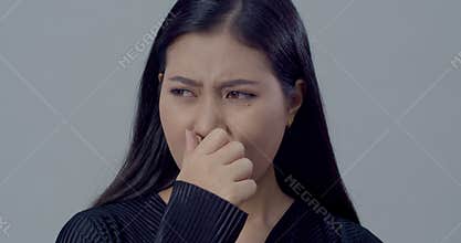 Face of Young woman with emotion feeling bad smell