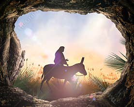 Silhouette Of Jesus On Donkey At Sunrise Seen From Empty Cave