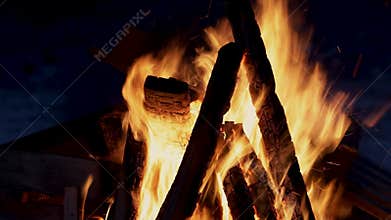 Night time and burning fire. Bonfire. Closeup of flames burning on black background, silence and crackle of burning wood.