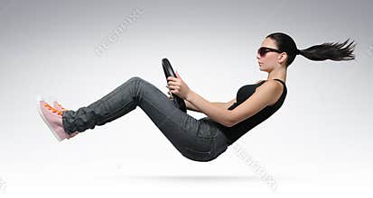 Young beautiful girl driver with a wheel