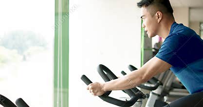 Man In The Gym  Exercising and Training On Bicycle