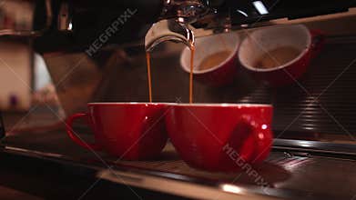 Espresso coffee. Making espresso coffee pouring shots on using two spout portafilter on espresso machine.