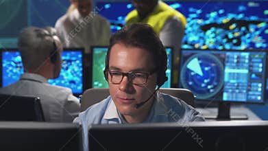 Workplace of the air traffic controllers in the control tower. Diverse team of aircraft control officers works using