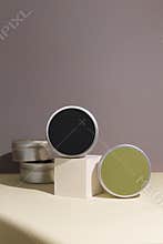 White cream in round aluminum metal tin on neutral background. Natural cosmetic product. Face and body skin care