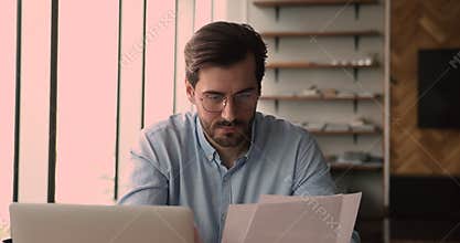 Businessman looking through documents learn terms conditions smiles feels satisfied