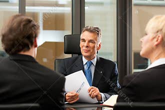 Lawyer or notary with clients in his office