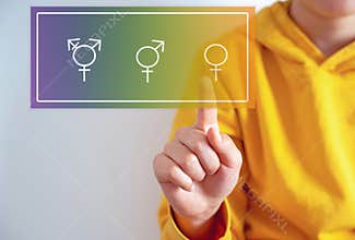 Family issues Gender confusion in teenager.  A teen boy pointing at gender symbols of male bigender and transgender. Concept of c