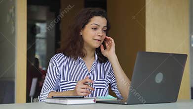 Happy latin girl talking, video conference calling online using laptop.