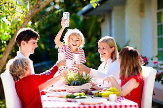 Family eating outdoor. Garden summer fun