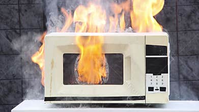 Microwave oven caught fire and caused domestic fire.