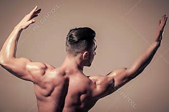 Mens heals body care. Dieting and fitness, healthy lifestyle. Athletic bodybuilder man on beige background. Man with