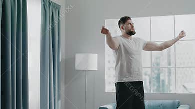 Muscular athlete with beard warms up elbows and hands