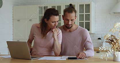 Stressed young married family couple having financial problems.