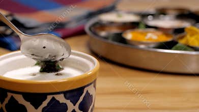 Seasoning of south Indian Chutney with curry leaves and black mustard seeds
