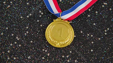 Gold medal with ribbon for champion on Festive black background.