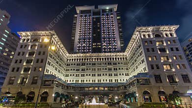 City traffic near The Peninsula hotel Hong Kong timelapse hyperlapse at night, located in Tsim Sha Tsui, Kowloon, Hong